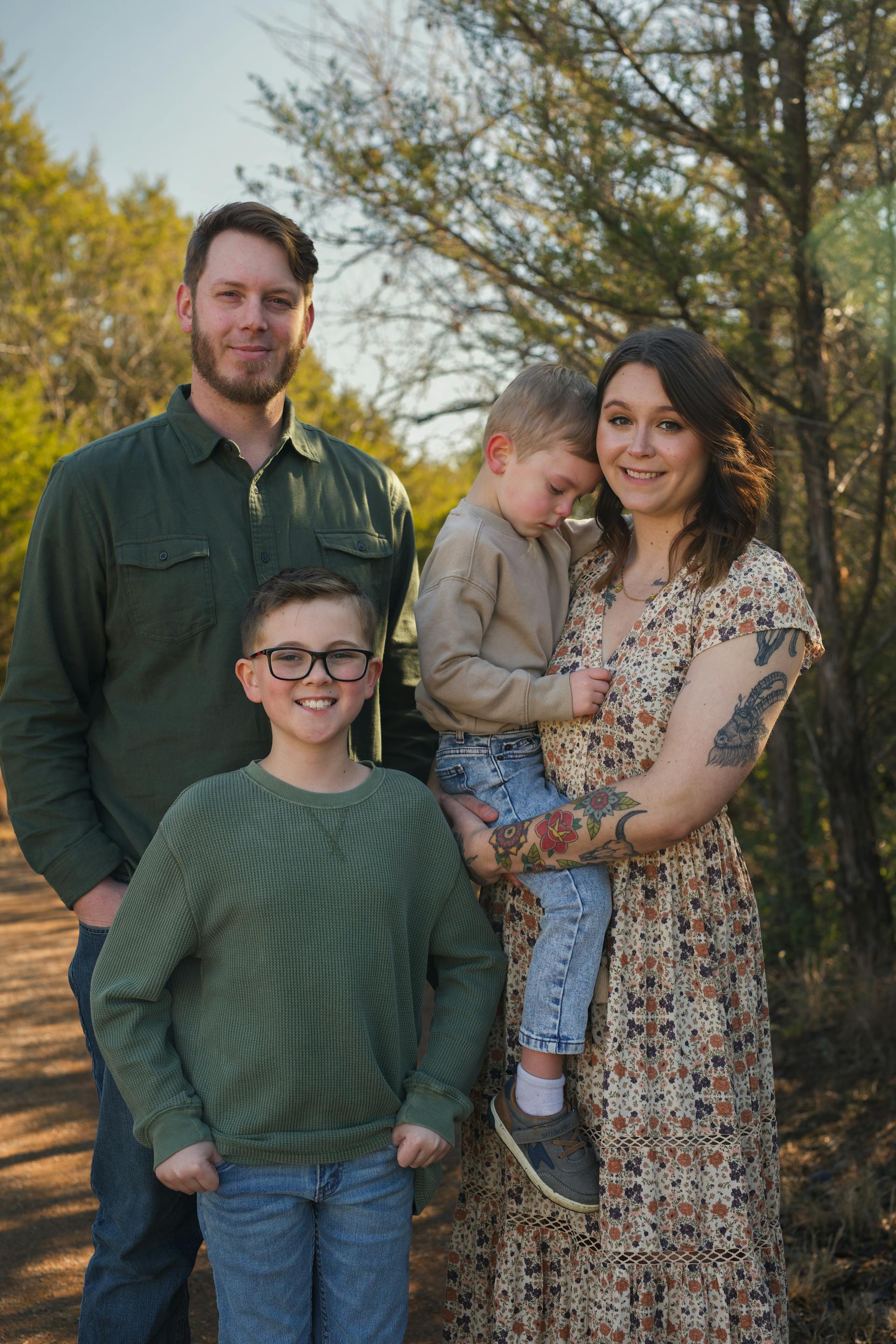 A couple with their two sons standing in a park | Source: Pexels