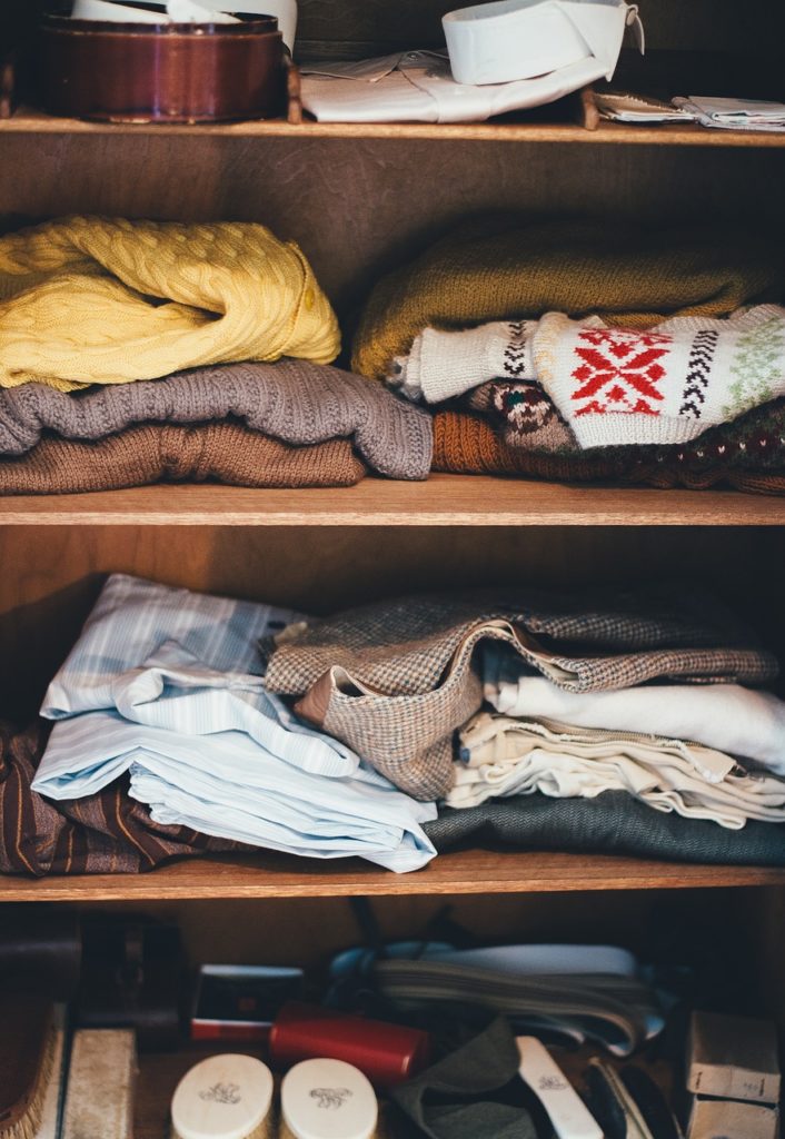 Closet full of sweaters. 