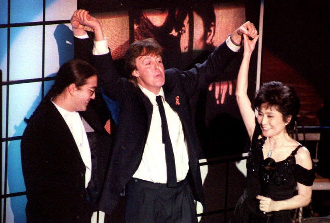 McCartney held up the hands of the late John Lennon's son and wife, Sean Lennon and Yoko Ono, after Lennon was inducted into the Rock and Roll Hall of Fame on Jan. 19, 1994.