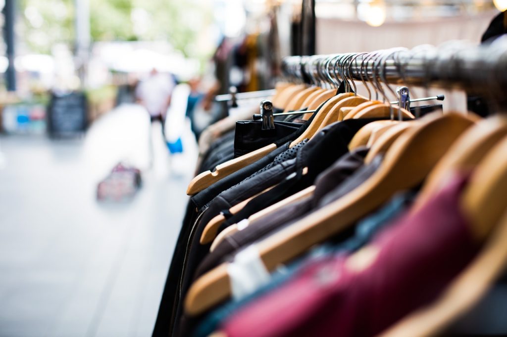 Clothing rack outside. Blurred background. 